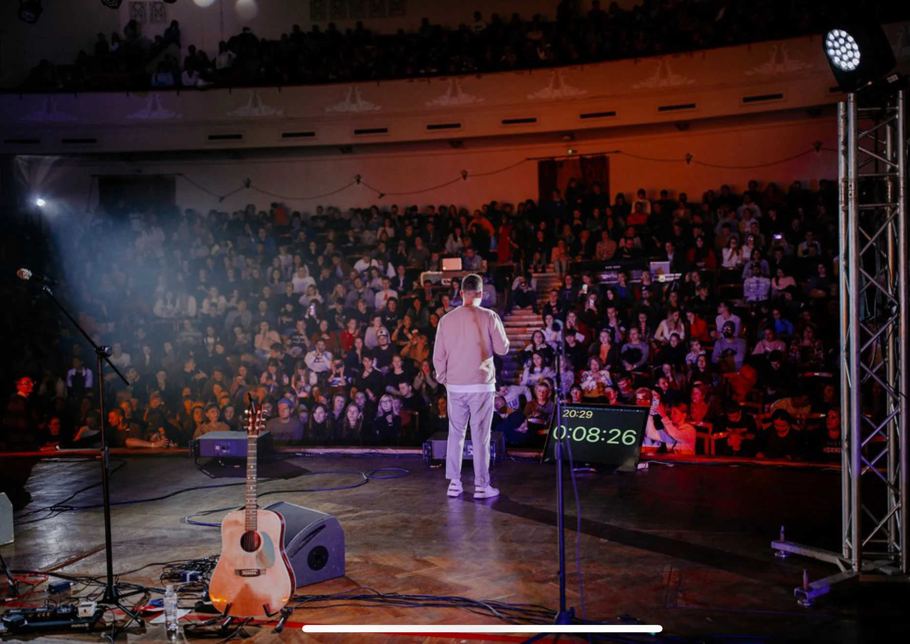 Eugene speaking to a large auditorium