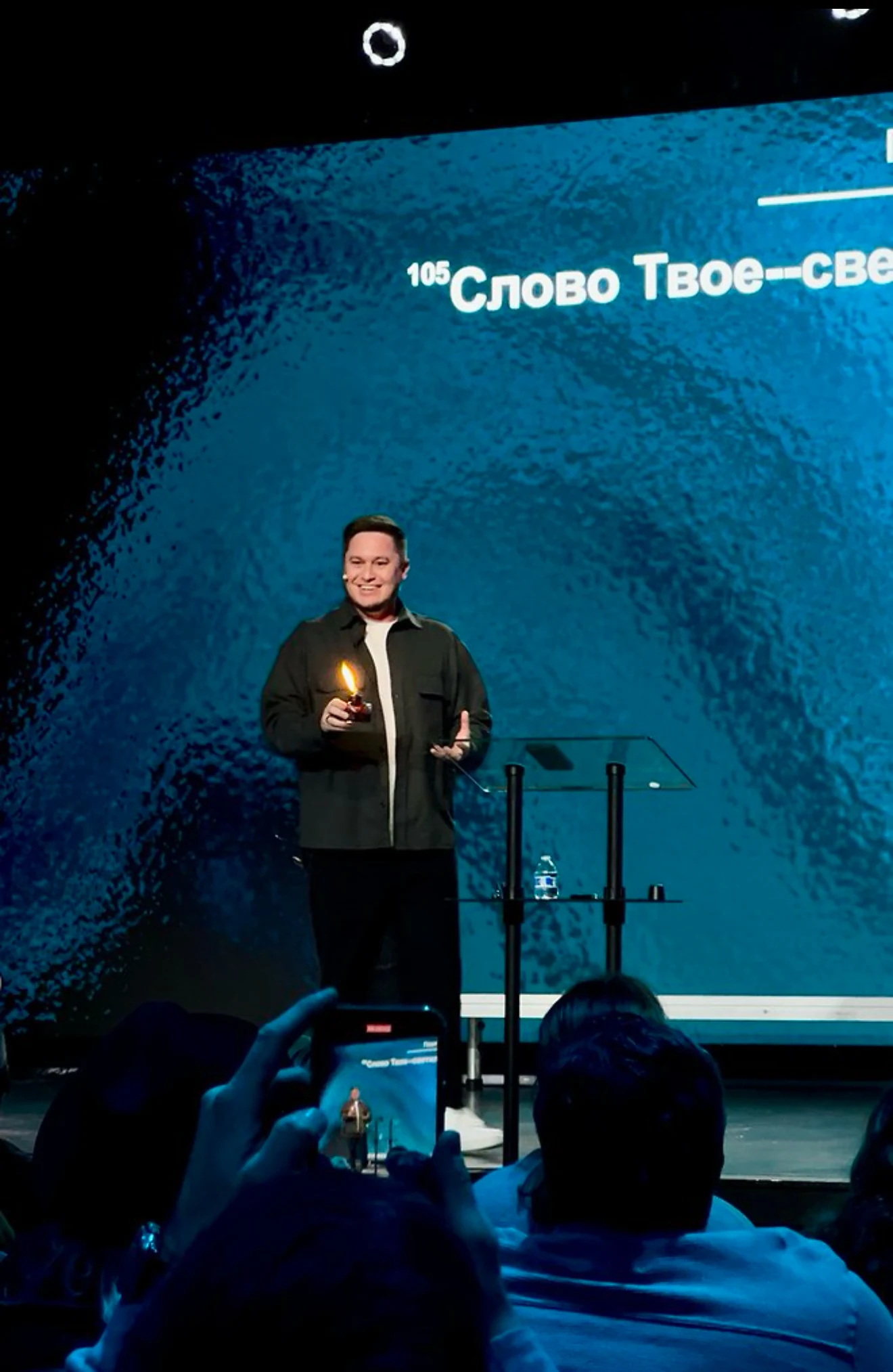 Eugene Voit preaching on stage