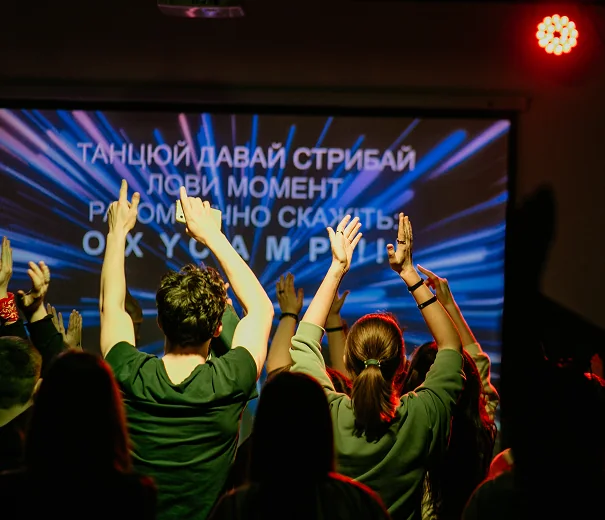 Young people worshipping together during a Christian camp